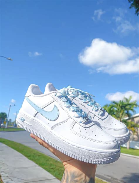 Light blue Air Forces with denim jeans and a white button-down shirt