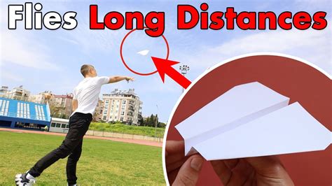 A person folding a paper plane to achieve a long distance flight