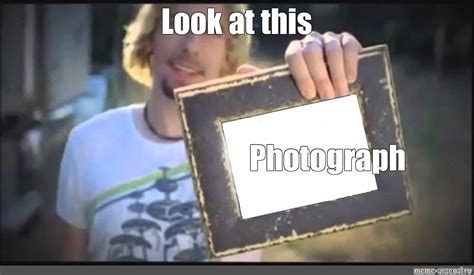 A picture of a person laughing at a photograph