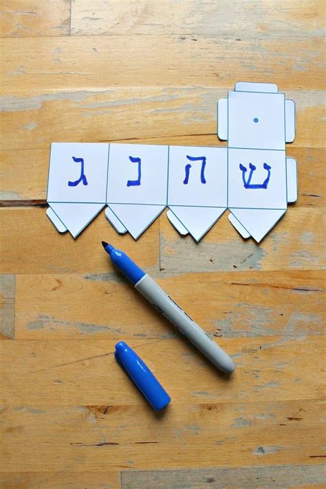 A child holding a homemade dreidel