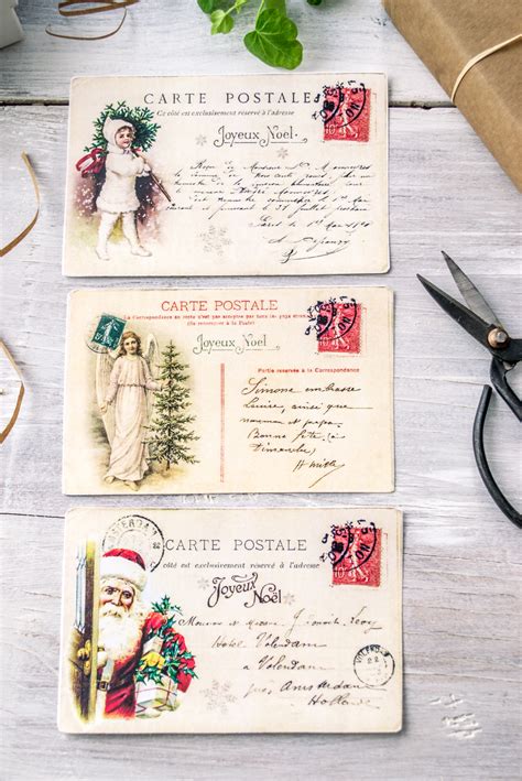 A person creating their own vintage-style Christmas postcard using craft supplies