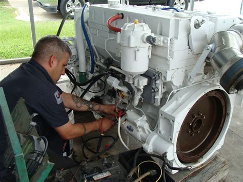 Marine diesel mechanic working on a ship's engine