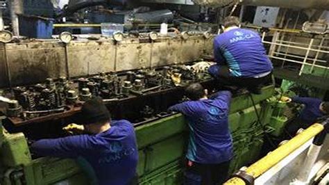 Marine engineer repairing an engine