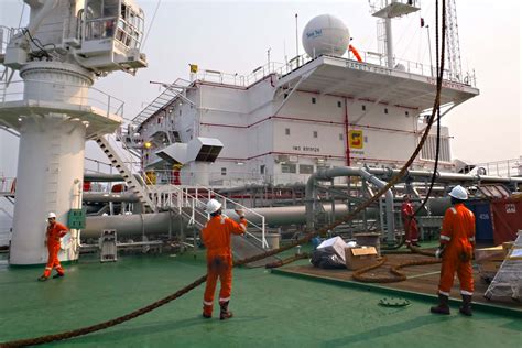 Marine engineers maintaining equipment