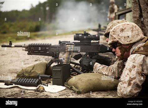 Marine machine gunner maintaining machine gun