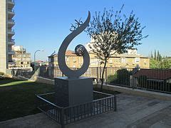 A memory garden with a variety of flowers and a statue