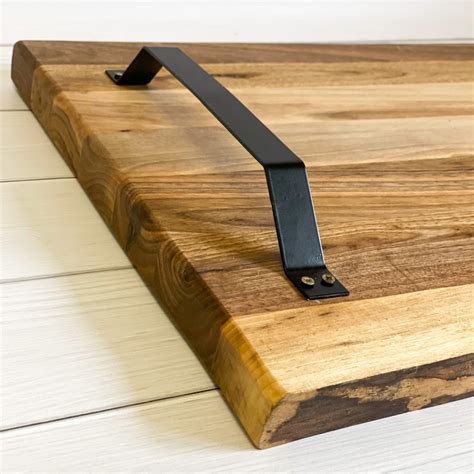 A metal handle for a cutting board