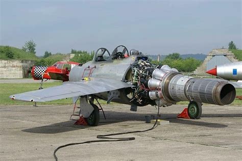 Technicians performing maintenance on a MiG-17