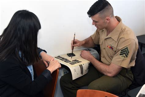 Military personnel working with language materials