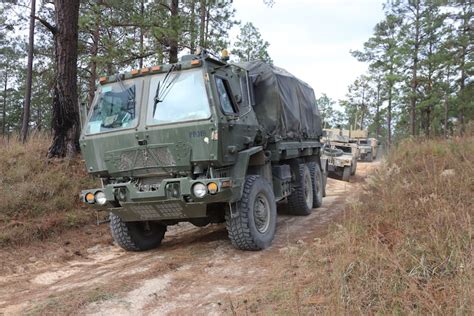 A military move truck driving down the highway