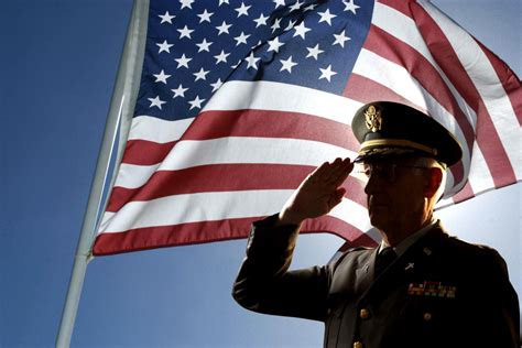 A group of soldiers saluting the flag