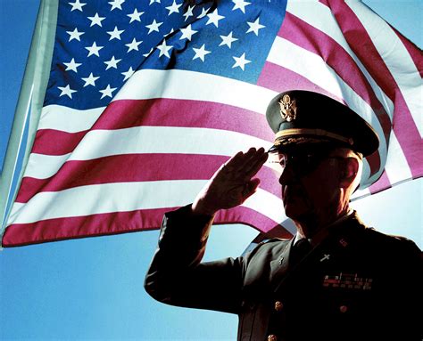 A soldier saluting a memorial