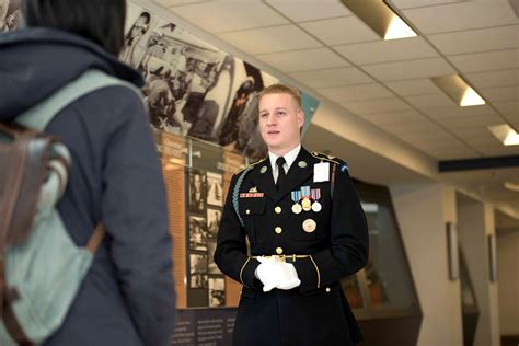 A soldier standing in front of a map of the world