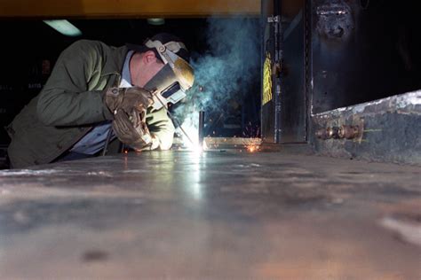 Military personnel welding in the field