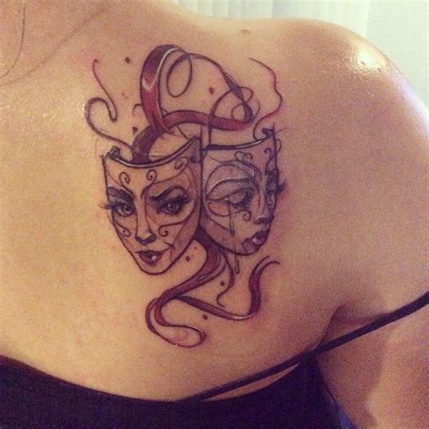 Modern mask tattoo design on a person's back