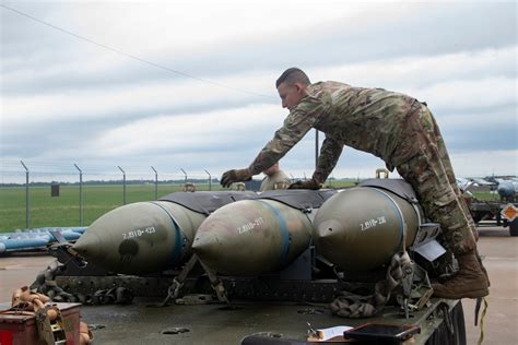 1st Munitions Squadron airmen loading munitions onto an aircraft