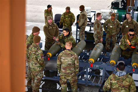 1st Munitions Squadron airmen loading munitions onto a rocket