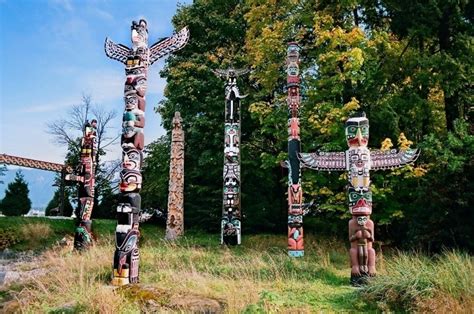 A collection of Native American totem poles featuring various animals and spirits