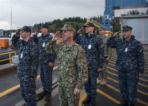 Naval personnel working on a ship at Navy Base Kitsap Bangor