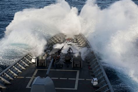 Navy ships navigating through rough seas