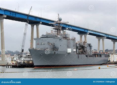 A Navy shipyard, with a Navy vessel in the background.