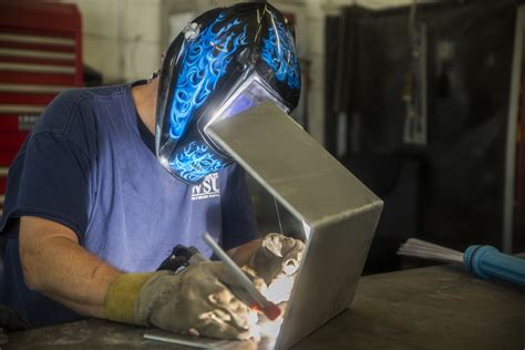 Navy Welder Inspecting Weld