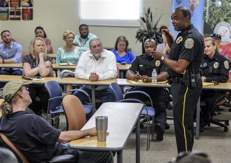 A neighborhood watch meeting discussing local crime trends