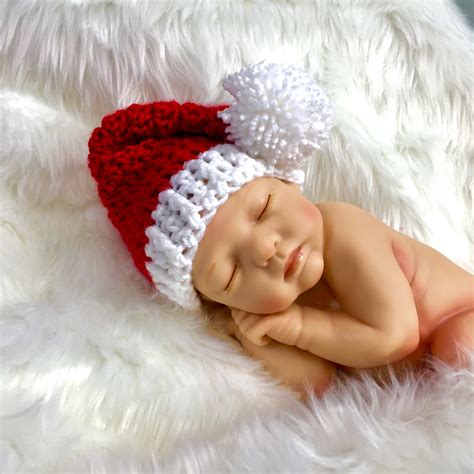 Newborn baby wearing a Santa hat