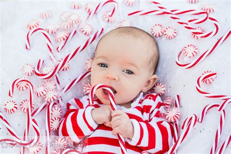 Newborn baby surrounded by candy canes