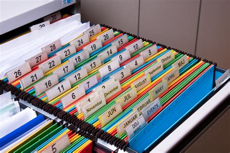 A file cabinet with hanging file folders labeled alphabetically