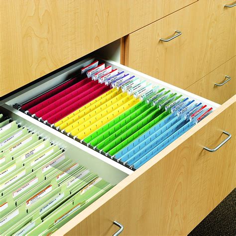 A file cabinet with hanging file folders labeled with different colors