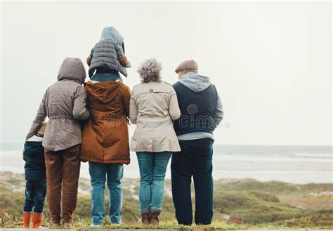 Family generations smiling together outdoors