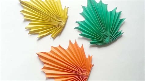 A paper craft design featuring leaf stencils