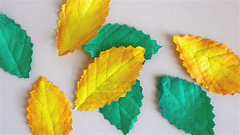 A paper craft design featuring leaf stencils