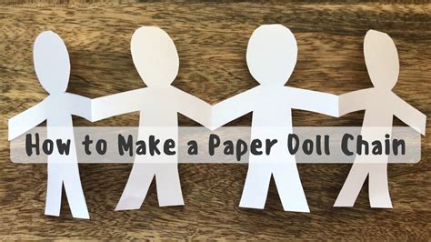 Adults creating paper doll chain