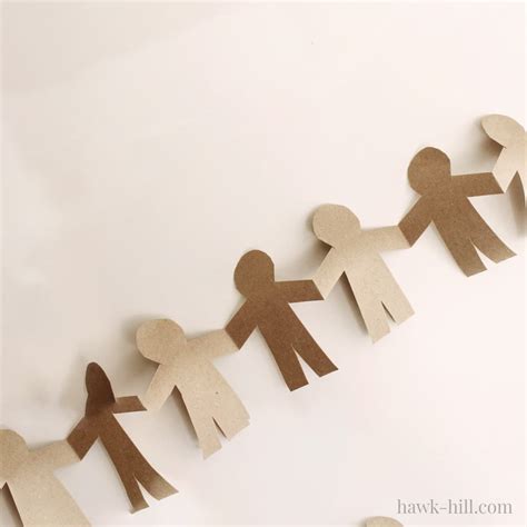 Kids playing with paper doll chain