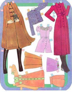 Paper dolls lying on a desk with colorful clothing and accessories