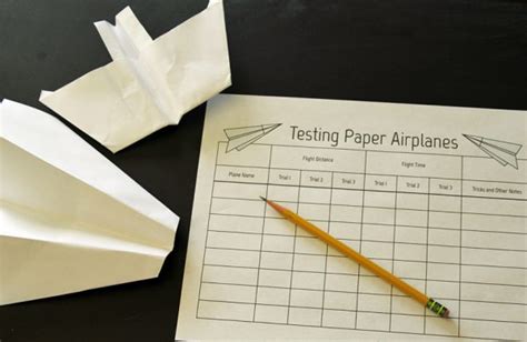 A person conducting flight tests with a long distance paper plane