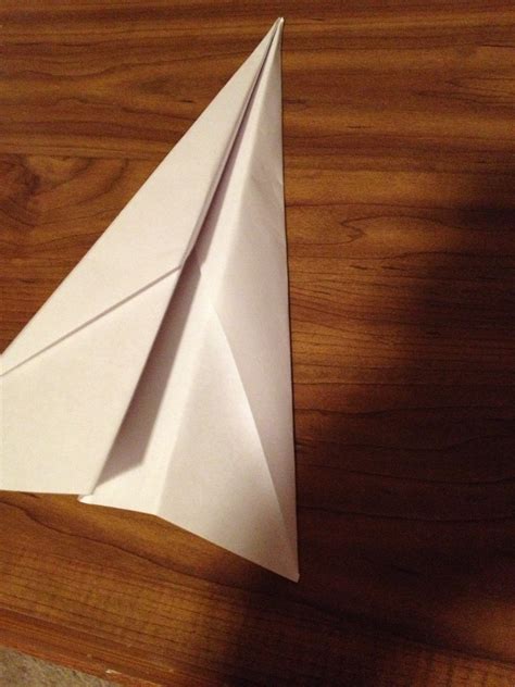 Paper plane soaring through the air