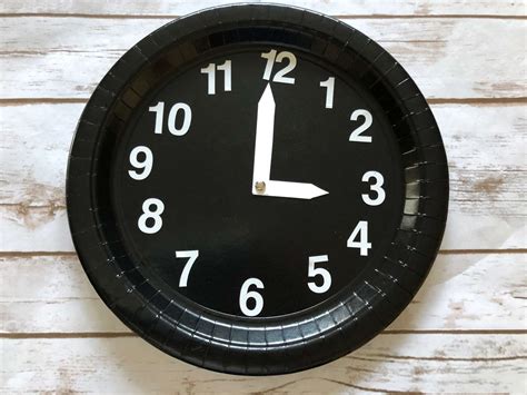 A paper plate clock template with Roman numerals