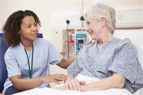 Physical therapy assistant communicating with patient