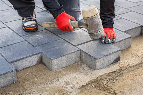 A paver laying asphalt on a road on a construction site