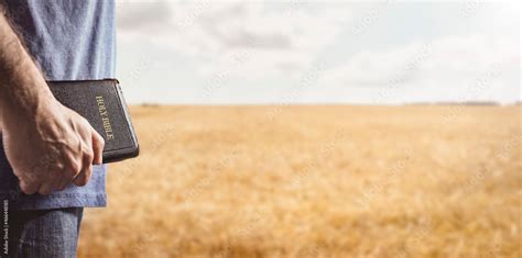 Person Holding a Bible