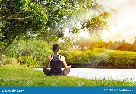 A person meditating in a peaceful natural setting