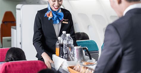 Personal flight attendant serving passengers on a private jet