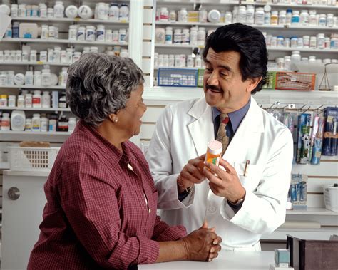 Pharmacy Technician Assisting Patient