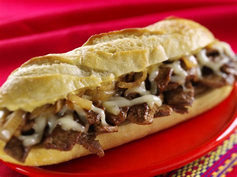 A Philly Cheesesteak sub sandwich, featuring thinly sliced beef and melted cheese