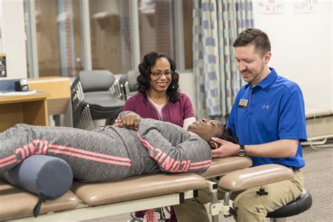 Physical therapy assistant working with a patient