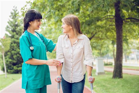 Physical Therapy Assistant helping a patient walk