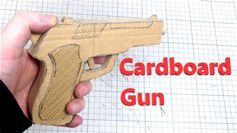 A person holding a cardboard gun